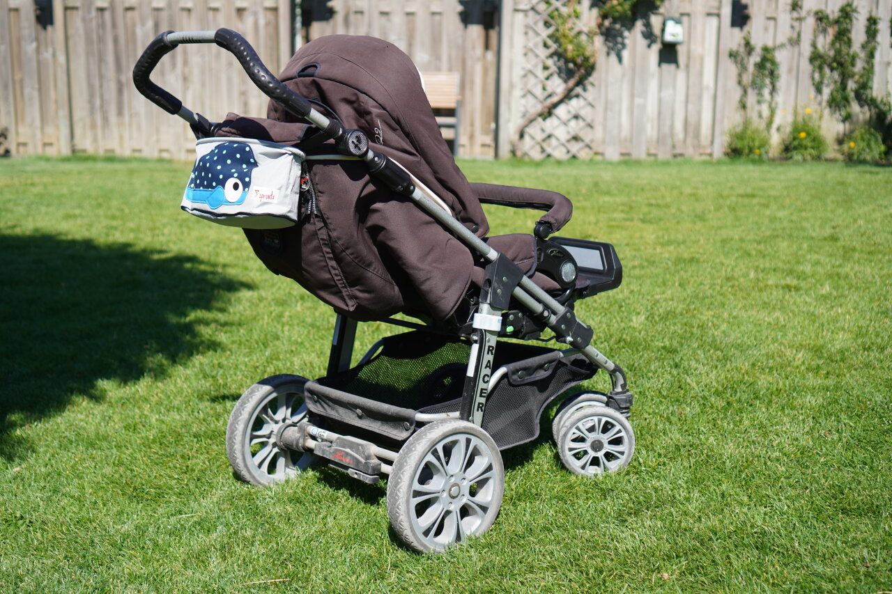 Baby stroller on a lawn.