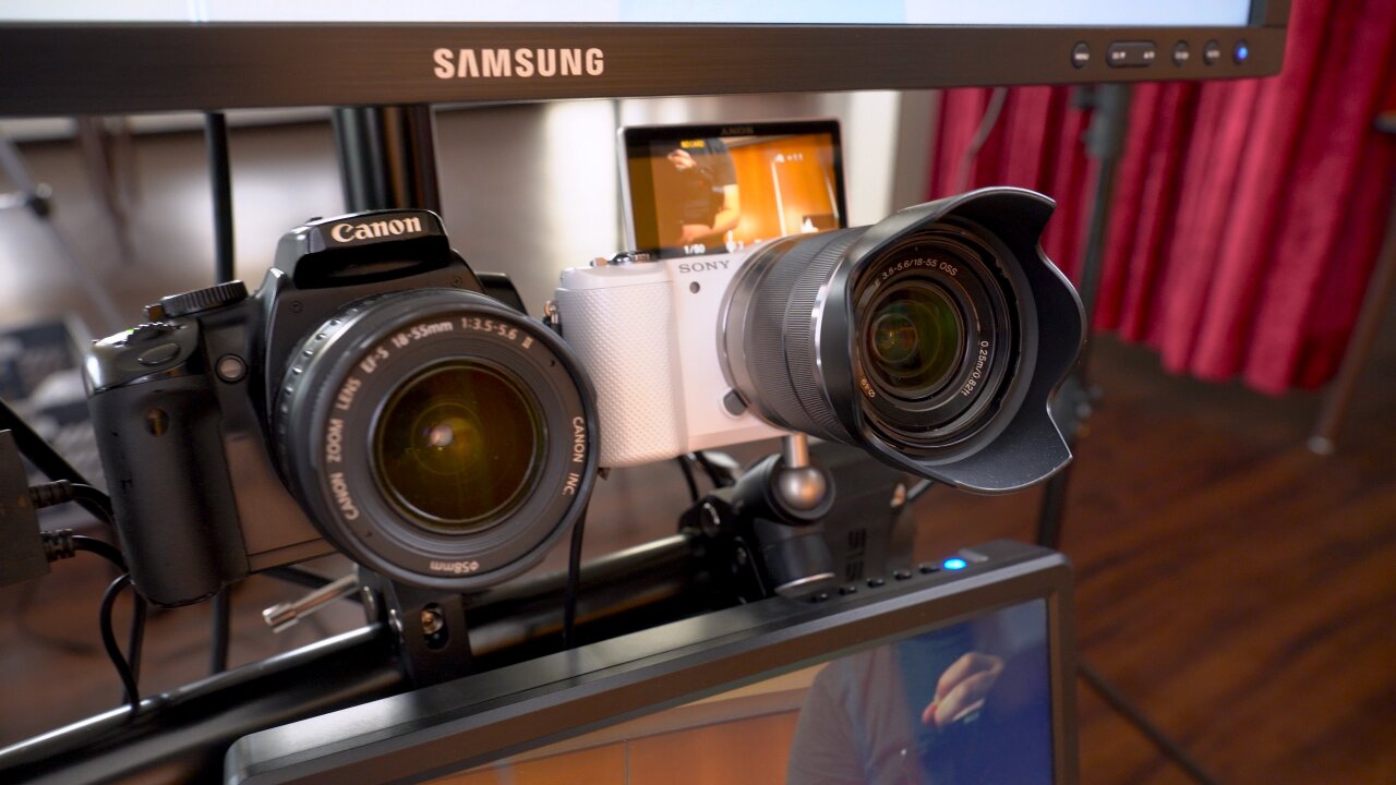 Detail shot of two cameras on the bullet time rack: A black Canon EOS 400d and a white Sony a5000.
