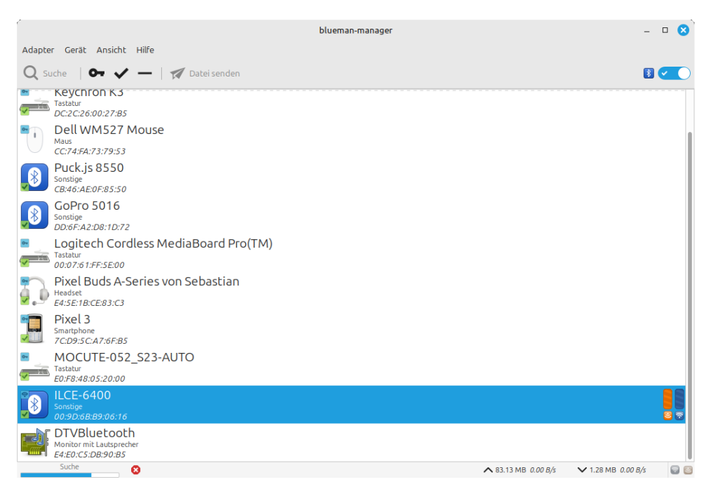 Screenshot of the Bluetooth device list on Linux Mint. It shows a list of Bluetooth devices with their Mac addresses and next to icons representing the type of device like a phone, a speaker or a keyboard. Smaller icons are superimposed on thises device icons, representing the state of connection or pairing like a blue key or a green checkmark. One entry is highlighted, which is the paired and connected camera with the name label ILCE-6400.